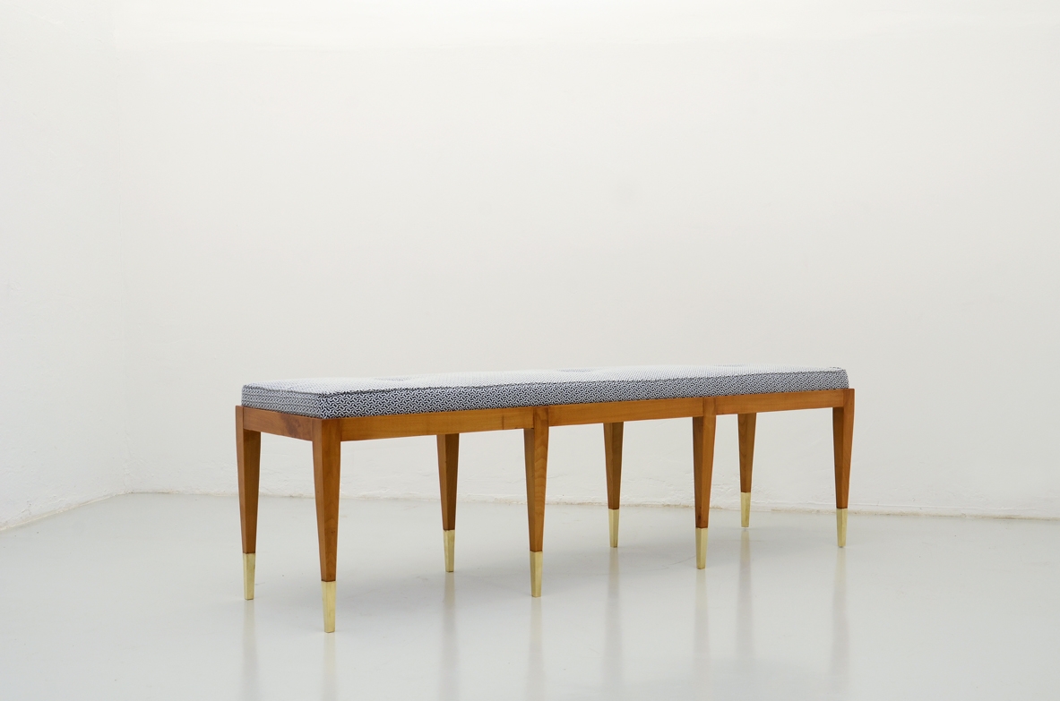 Elegant bench in cherry wood with nice and thin brass tips.