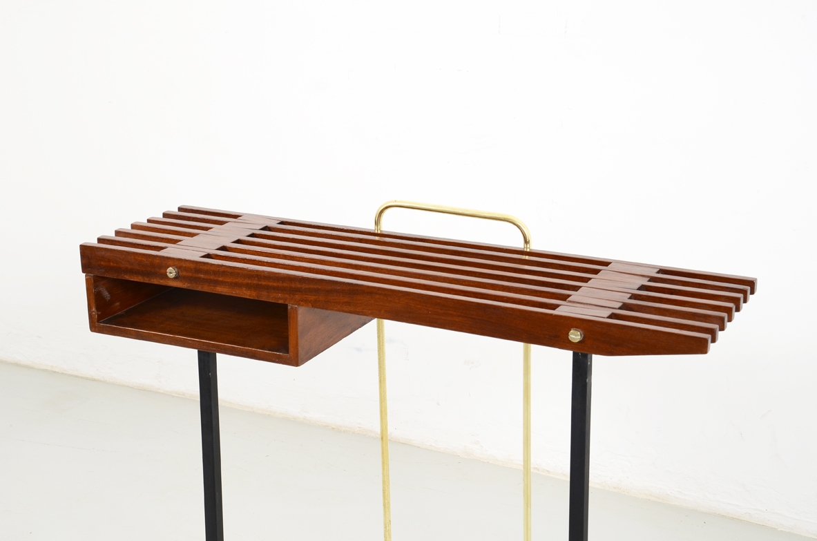 1950's Italian console table in teak wood, metal legs on front and brass O on the back.