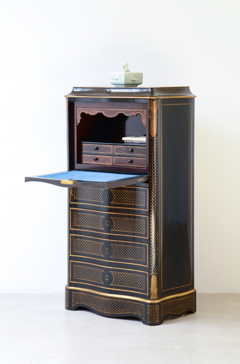 French Napoleon III ebonized wood cabinet with brass inlays, three drawers, fall-front compartment and shaped front and sides, circa 1850.