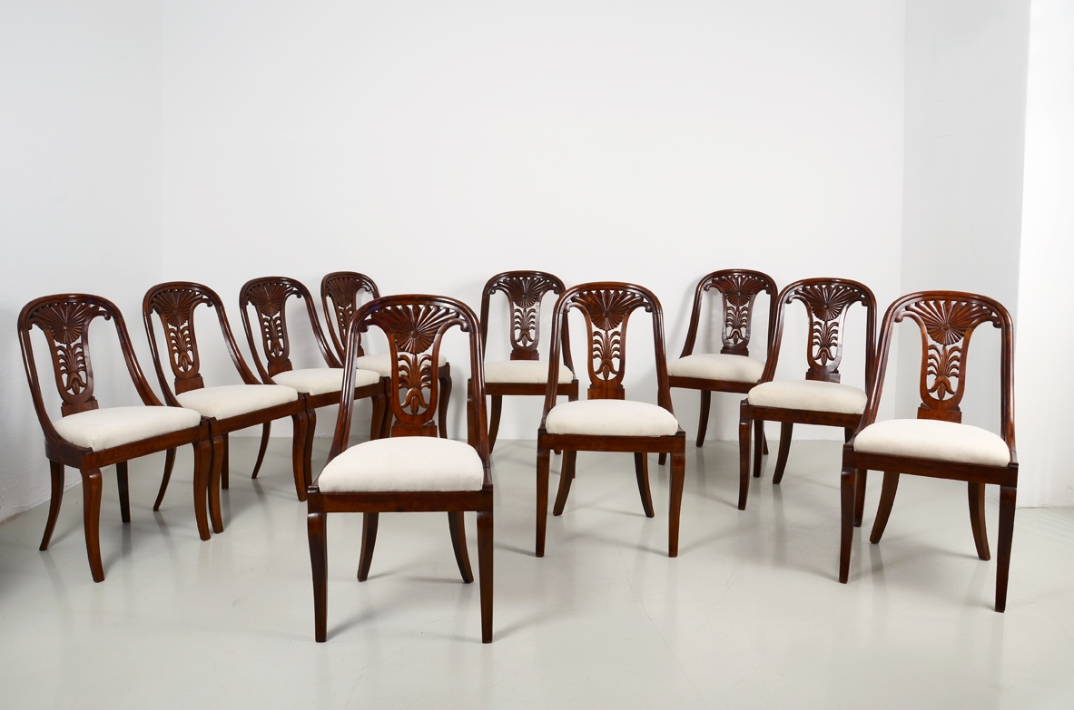 Elegante gruppo di 12 sedie a pozzetto con schienale a giorno finemente intagliato. Epoca Carlo X, Nord Italia, 1820/1830ca.