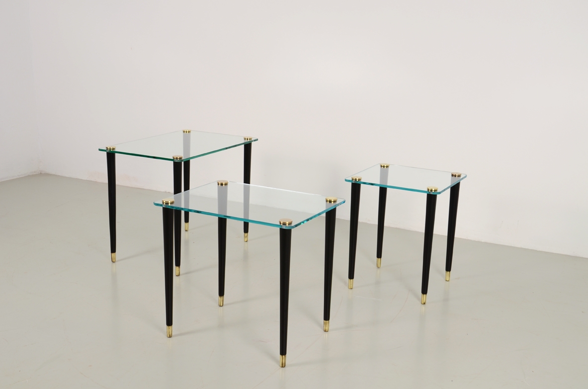 Set of 3 small coffee tables with crystal glass top and thin legs with brass tips. Italy 1960's.