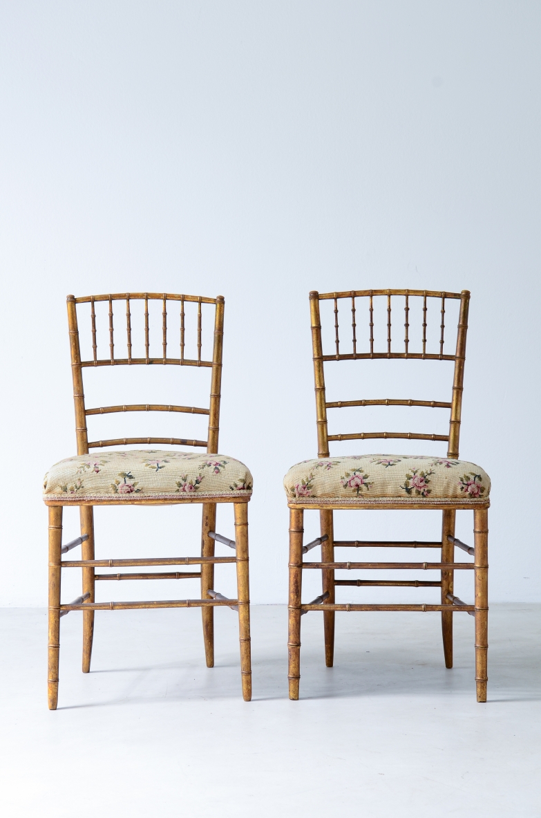 Pair of chairs in turned and gilded wood with upholstered seat with original embroidered fabric.  Italy, early XX Century.