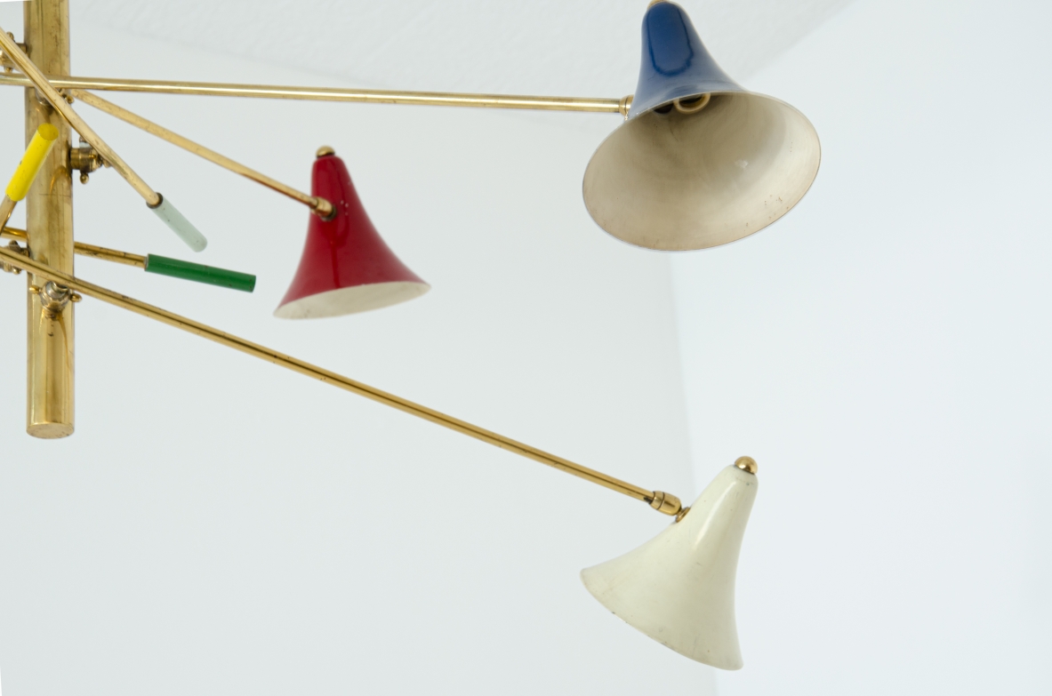 Rare suspension lamp with six adjustable brass arms and painted metal diffusers.  Italian manufacture, 1950s.