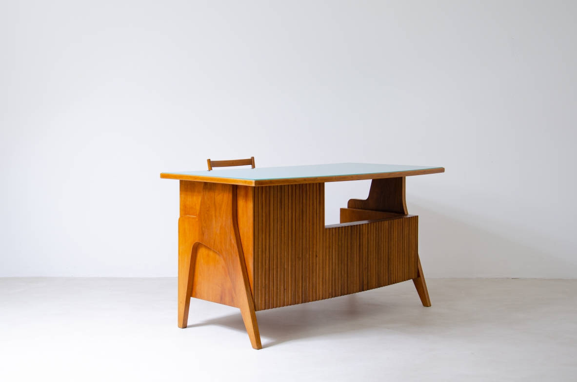 Oak desk with shaped uprights and ribbed wood structure, side drawers and green opaline glass top.  Turin school, Italy, 1950's.