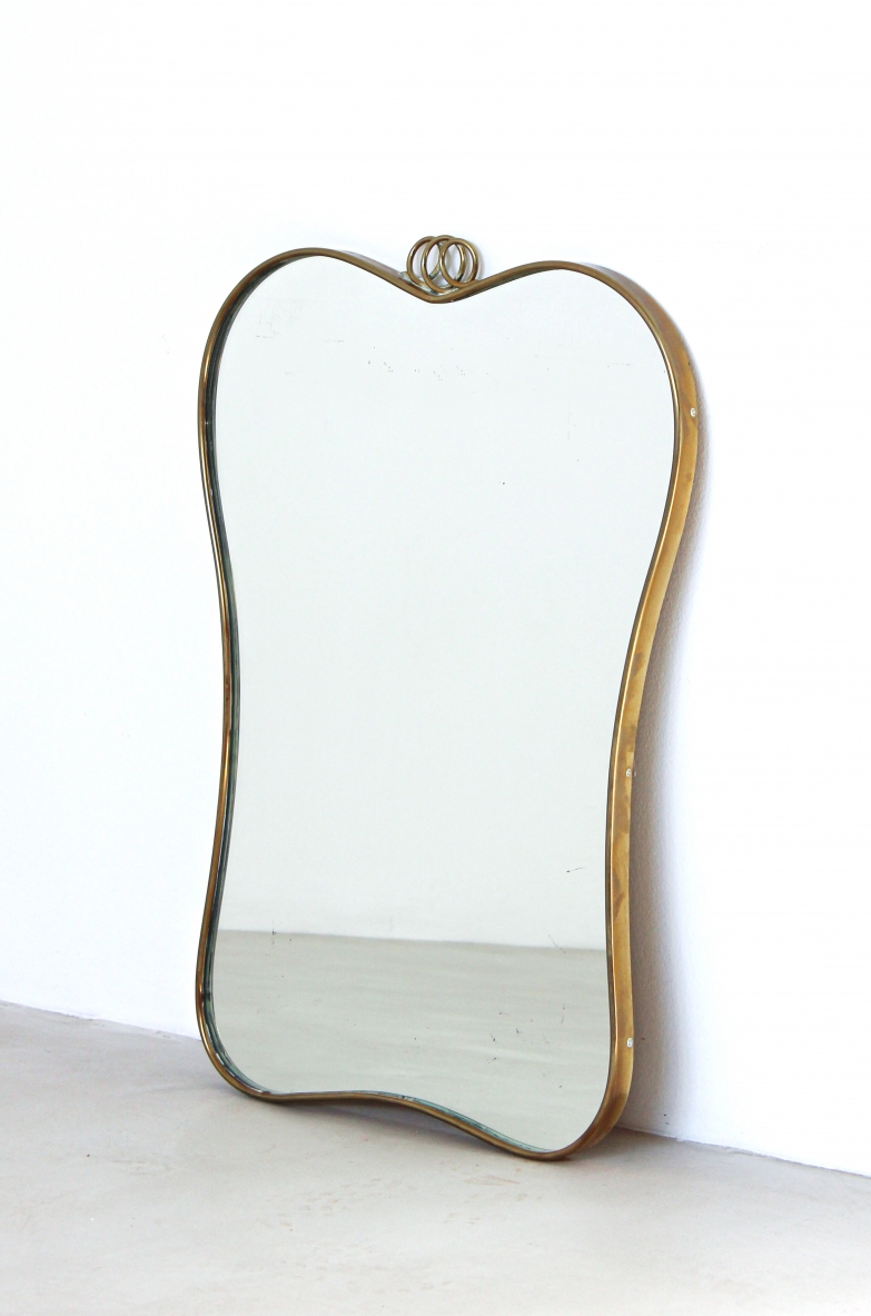Mirror with shaped brass frame. Italian manufacture, around 1950