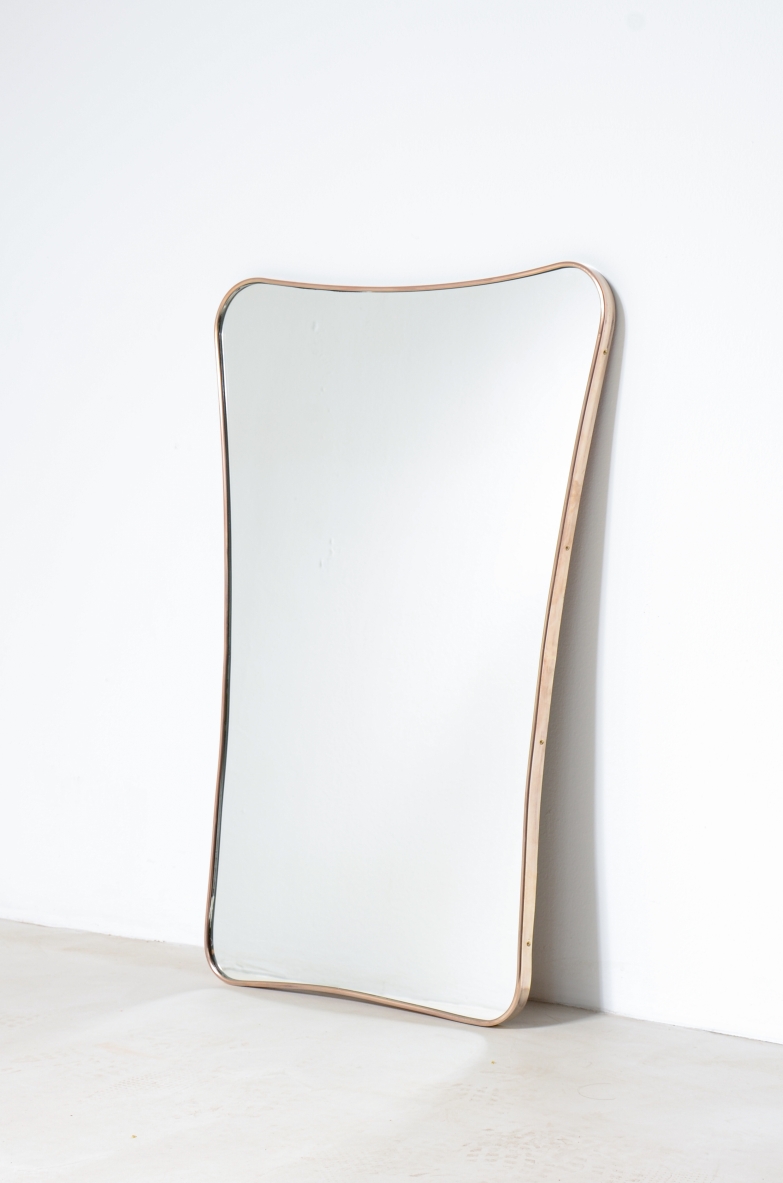 Elegant mirror  with shaped brass frame. Italian manufacture, 1950's.