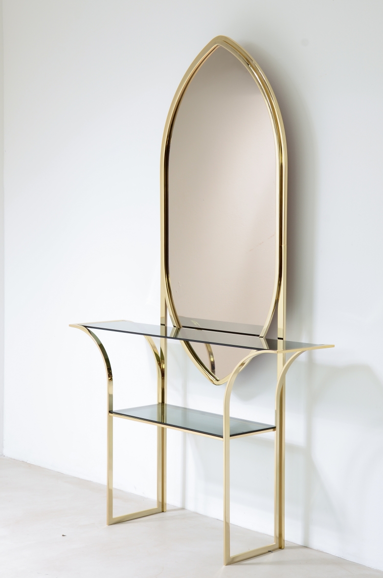 Italian console table circa 1970, with brass frame, large pointed-arch smoked mirror and grey-blue bevelled glass shelves.
