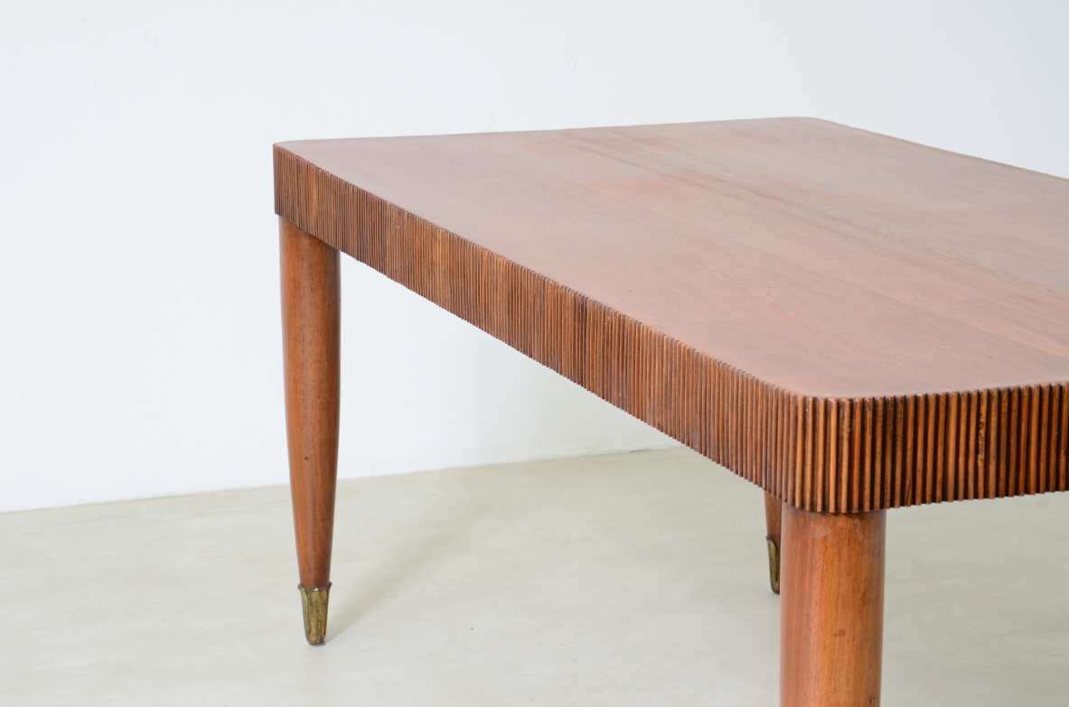 Elegante tavolo con motivo a fascia in legno grissinato, piano in legno di noce, gambe tornite con puntali in legno intagliato.  Manifattura italiana 1940 ca.