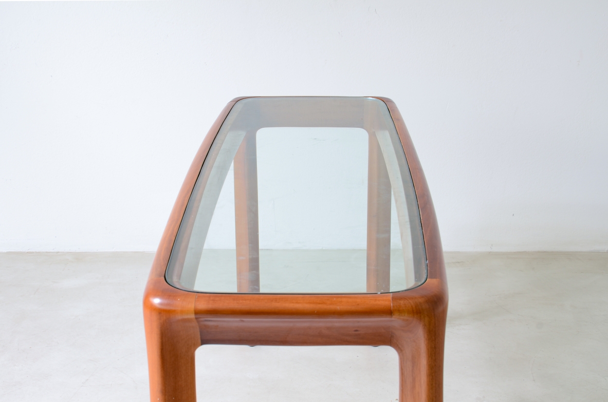 Angelo Mangiarotti (1921-2012)  Tavolo console con struttura in legno e piano in cristallo molato di forte spessore.