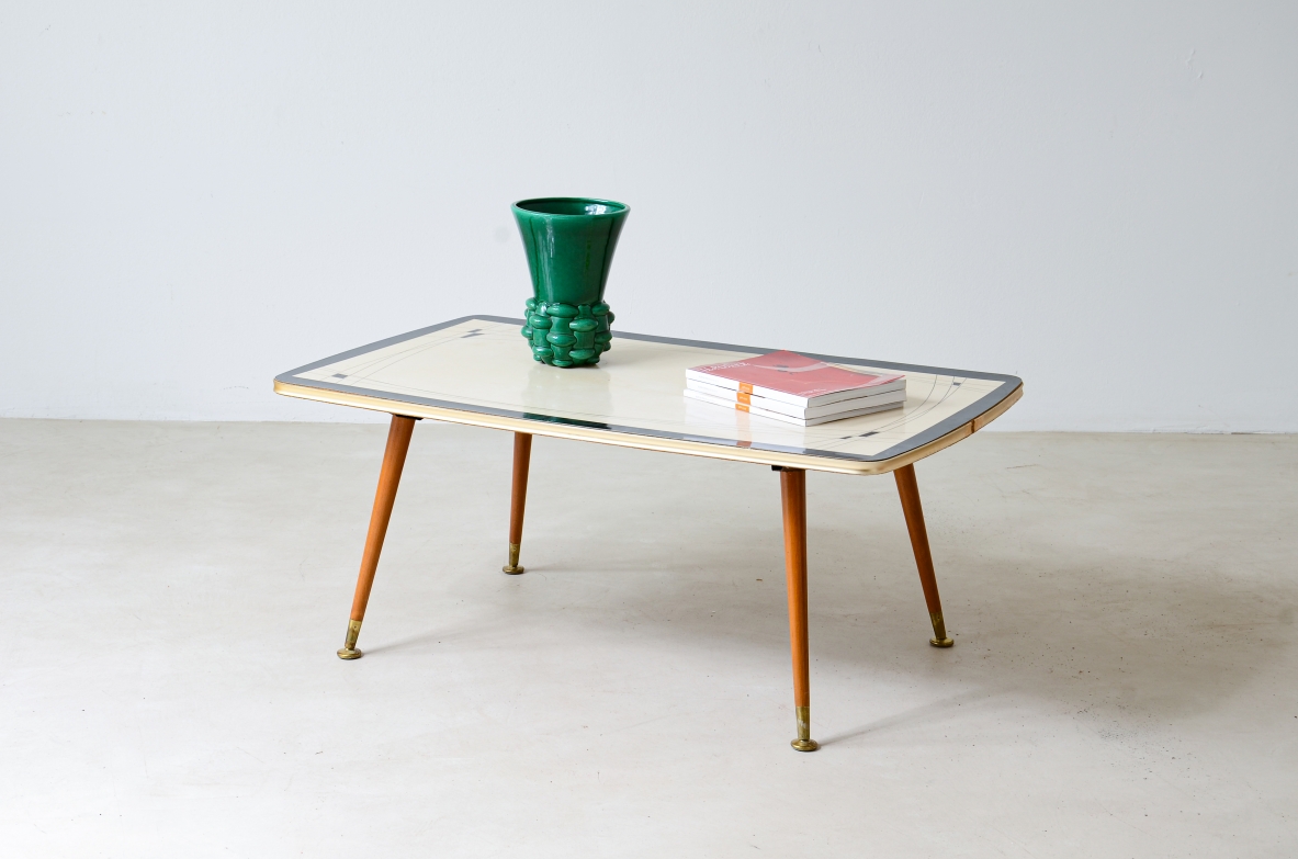Coffee table with decorated methacrylate top and four legs with brass ends.  France 1960s.