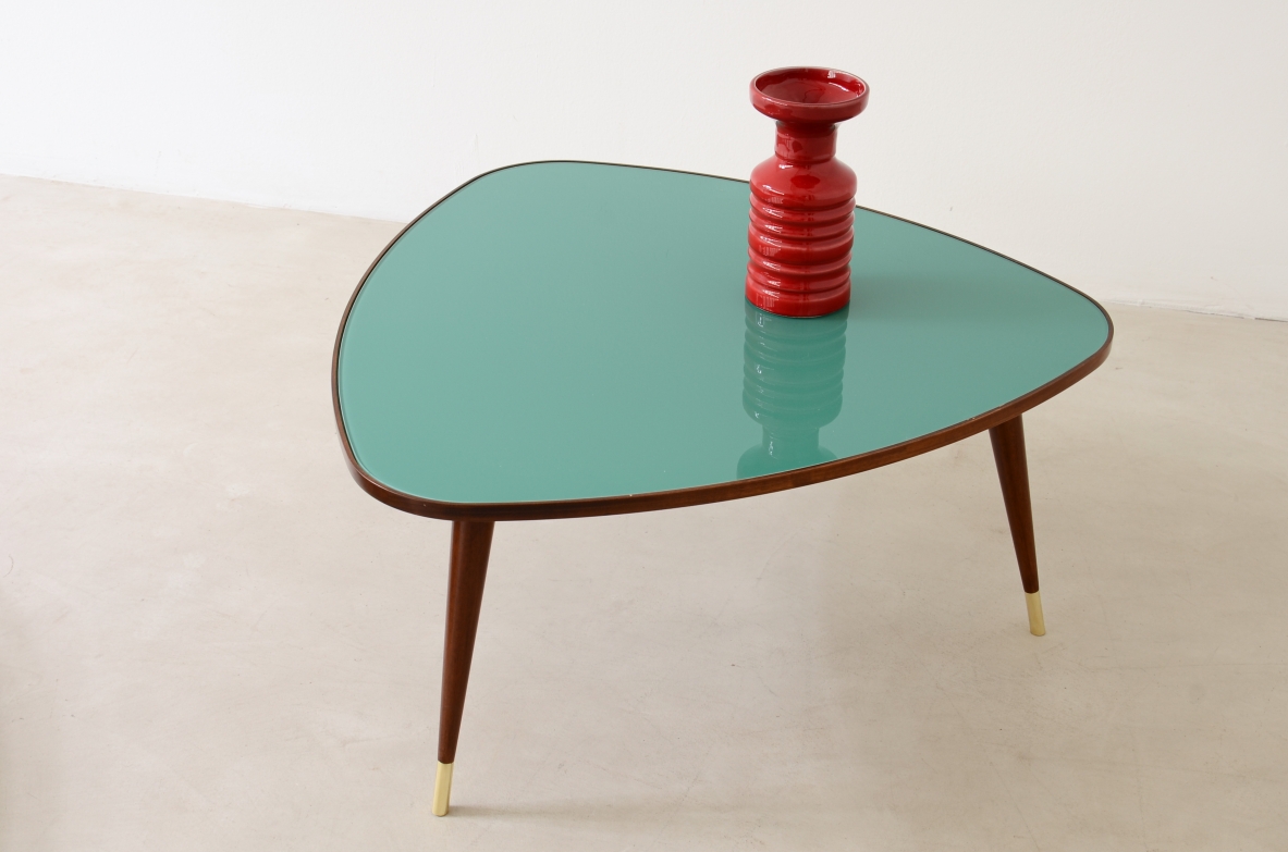 Osvaldo Borsani  Pair of coffee tables with cut glass top and truncated conical legs with brass tip.