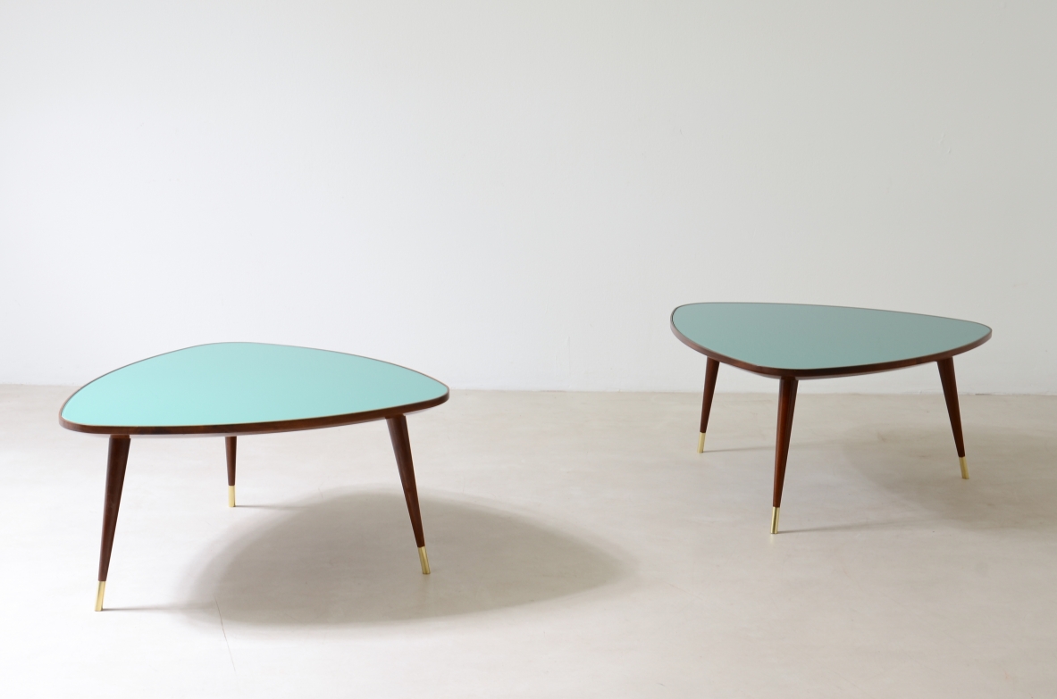 Osvaldo Borsani  Pair of coffee tables with cut glass top and truncated conical legs with brass tip.