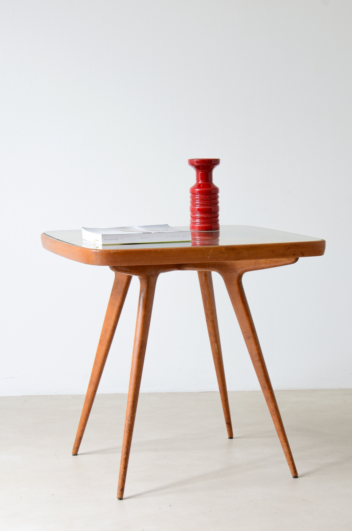 Table with visible cross on the top and legs and elegant thin legs.  Italian manufacture from the 1950s