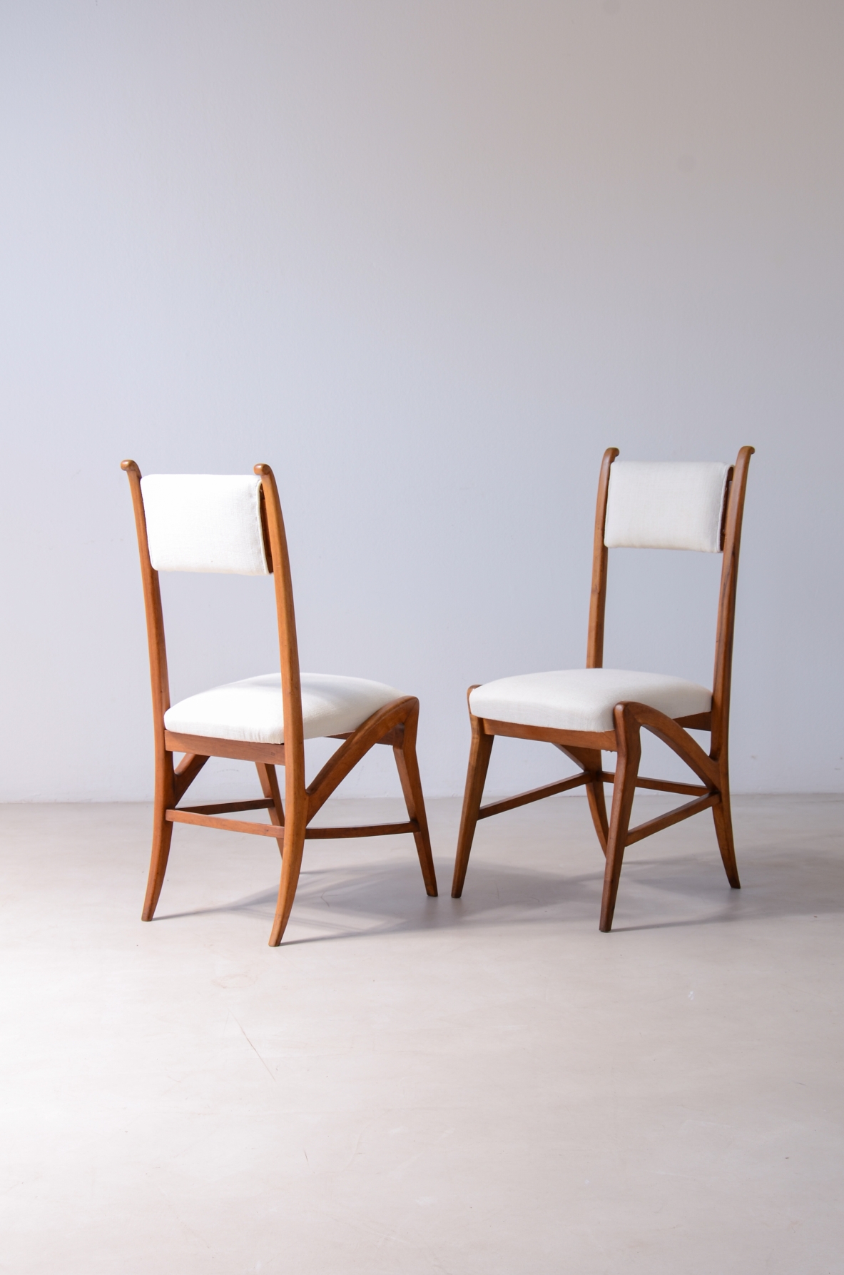 Coppia di straordinarie sedie in rovere con seduta e schienale in tessuto imbottito.  Attr.Guglielmo Pecorini, 1940ca.