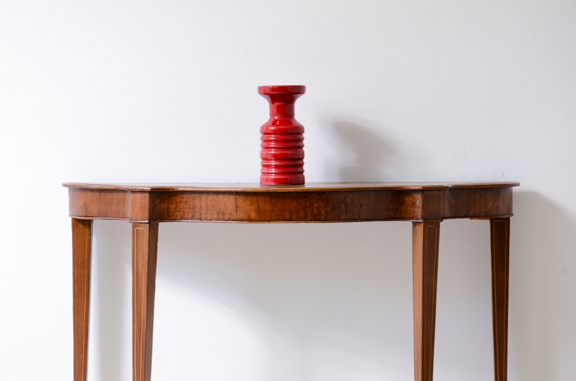 Small console in walnut with shaped top and thin tapered legs.1850