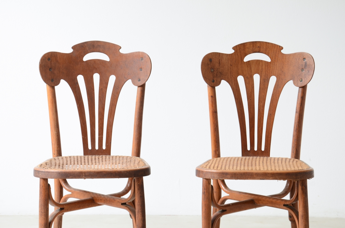Four bent beech and perforated wood chairs with cane seats.  Thonet manufacture, Austria, circa 1920s.
