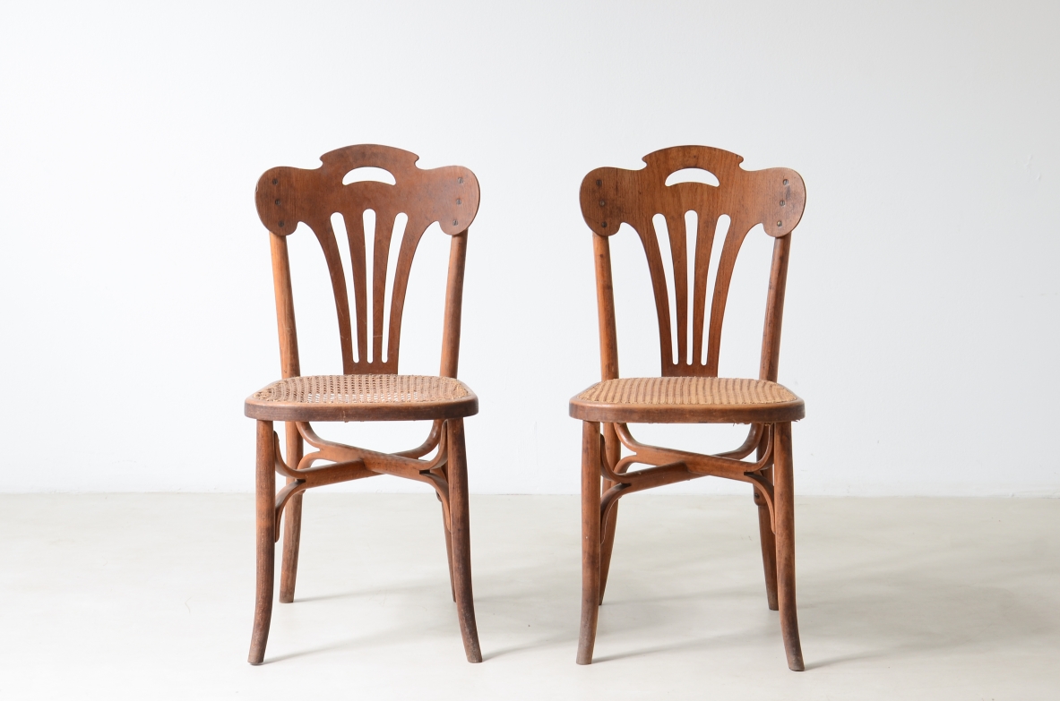 Four bent beech and perforated wood chairs with cane seats.  Thonet manufacture, Austria, circa 1920s.
