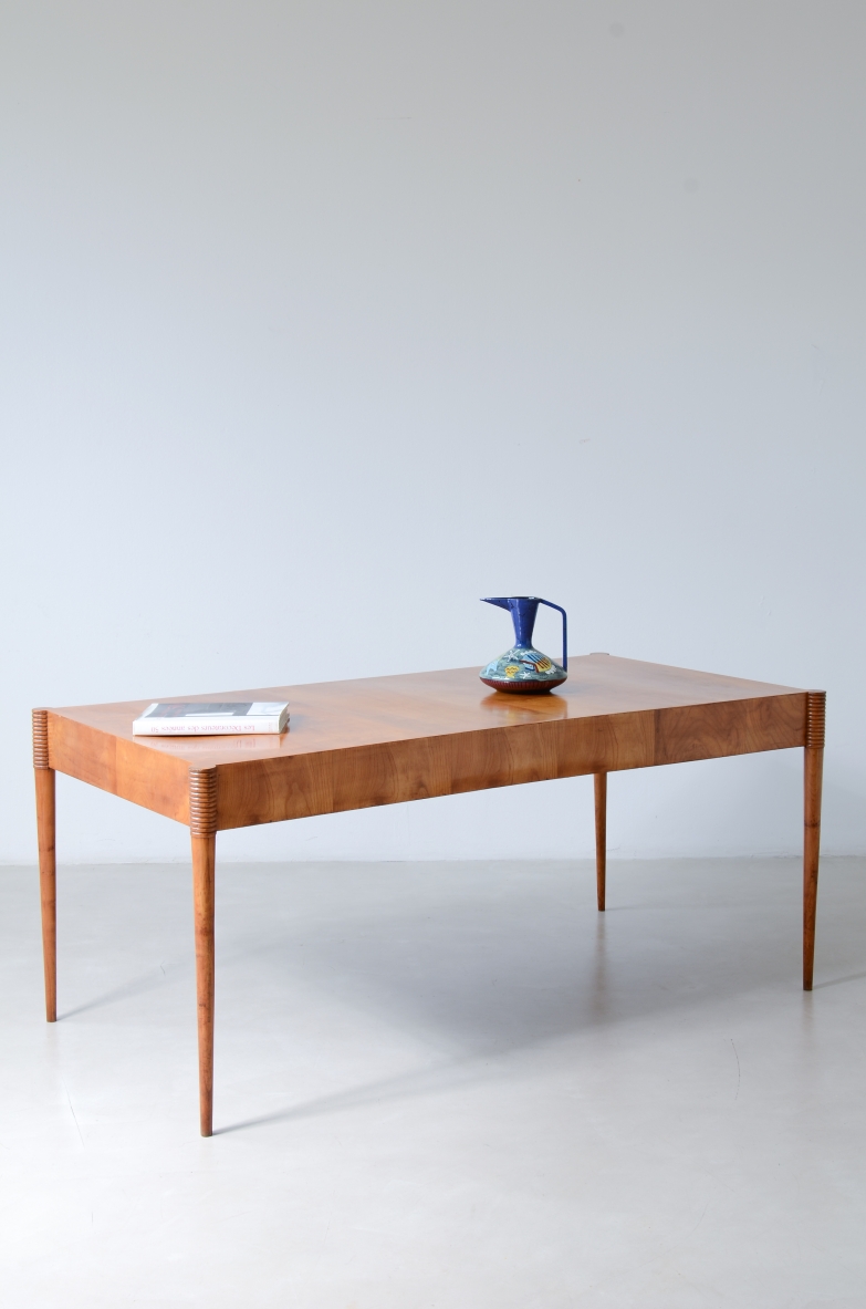Italian rectangular cherrywood table, c. 1935, with a clean-lined wooden top, apron decorated with turned discs and four tall tapered legs.