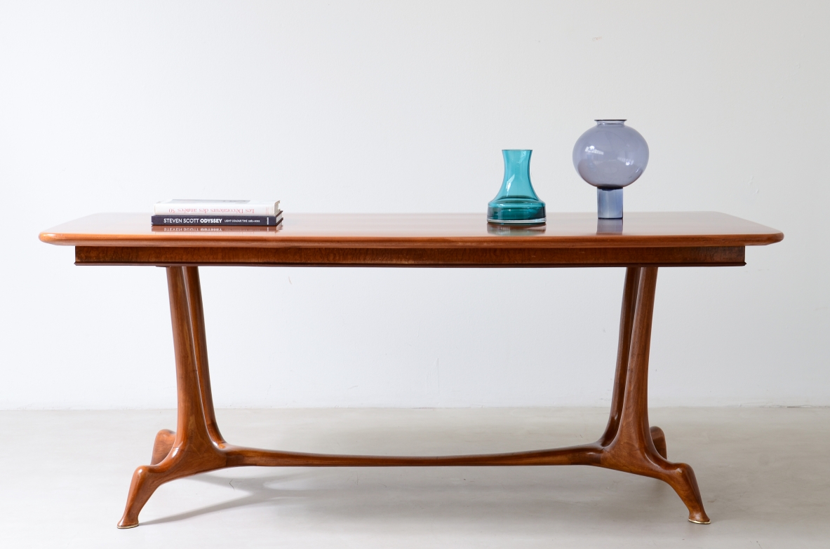 Unique cherry table with a sculptural base featuring taut lines, Made in Italy, circa 1950.