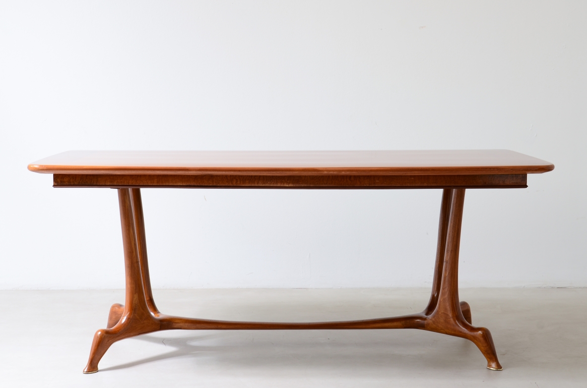 Unique cherry table with a sculptural base featuring taut lines, Made in Italy, circa 1950.