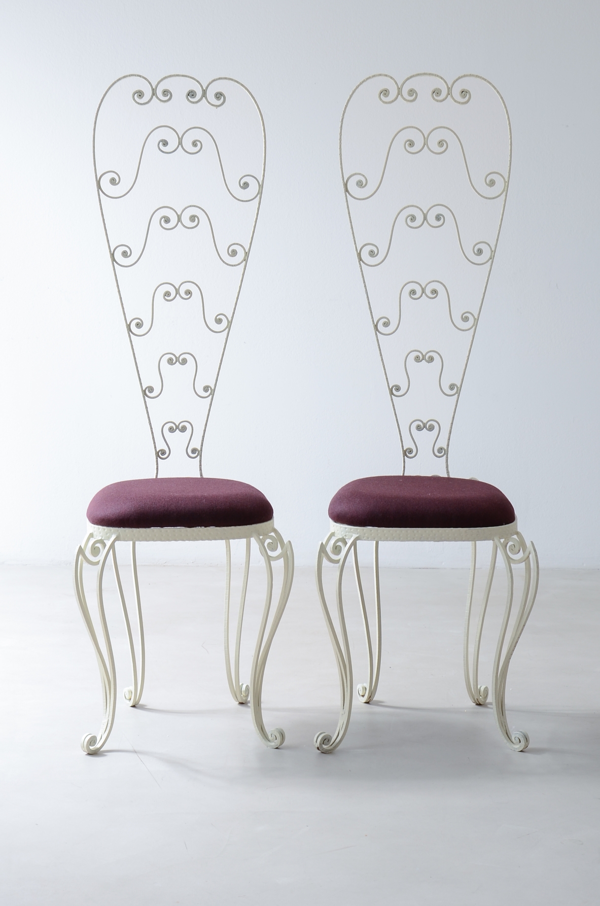 Pierluigi Colli 1950's Two wrought iron chairs with high backs decorated with curls