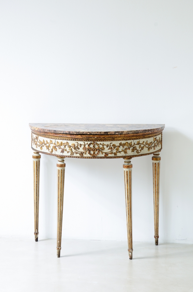 Console table in lacquered and gilded wood with Verona breccia marble top, richly decorated apron and four turned legs, front view with green vase.