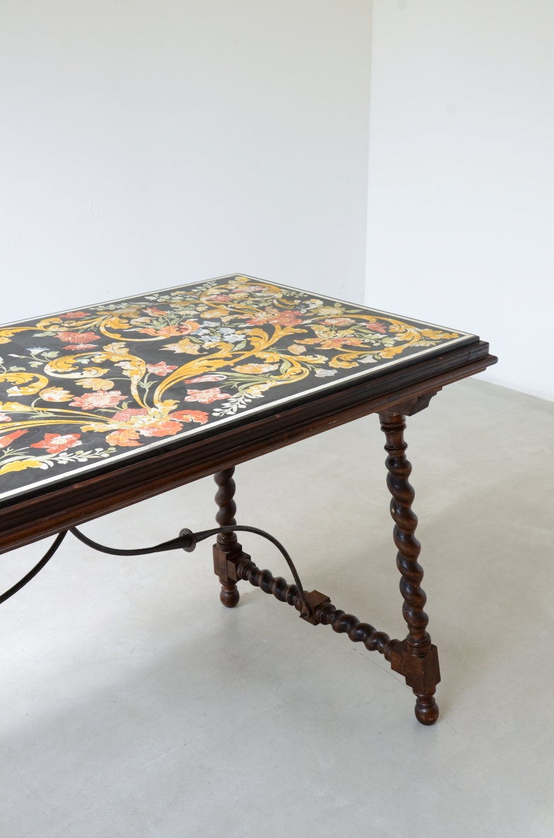 Early 18th-century Emilian table with a rectangular polychrome scagliola top decorated with floral scrollwork, spiral-turned wooden legs and curved wrought iron stretchers.