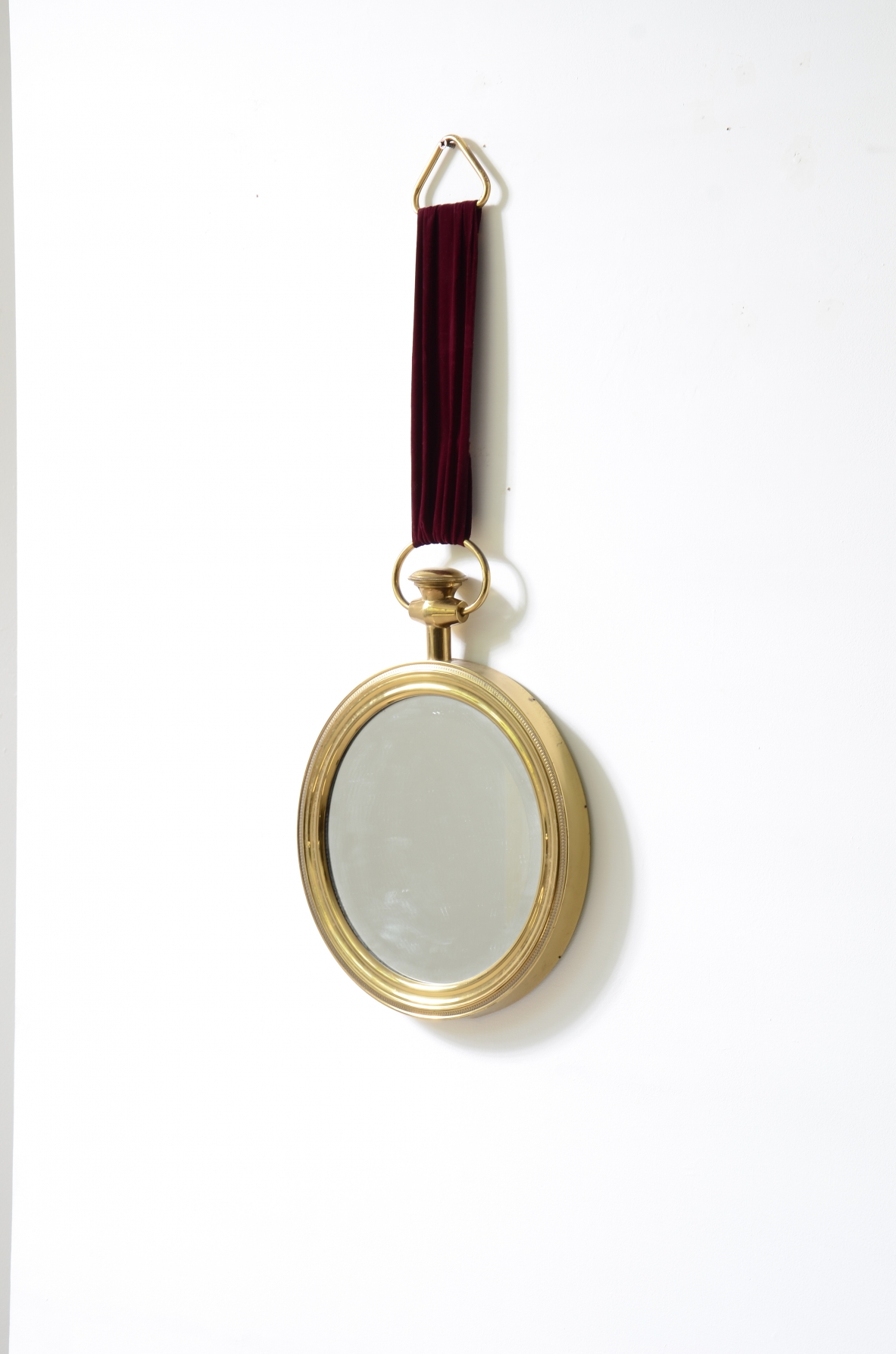 Elegant shaped brass mirror In the style of Piero Fornasetti. 1955