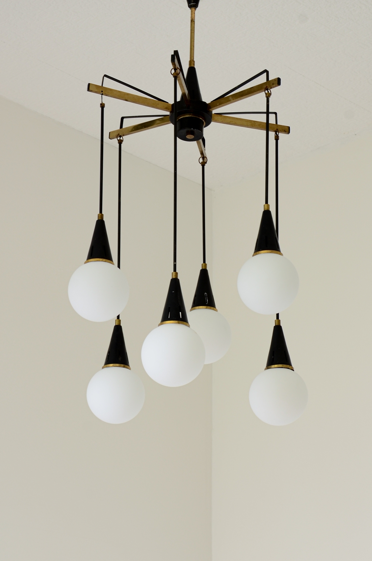 Six-light chandelier with brass arms and opal glass spheres 