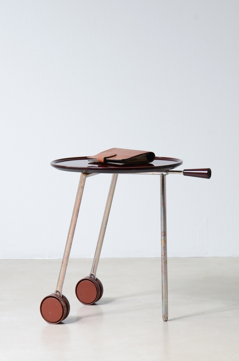 Italian Art Deco chrome and red Bakelite occasional table with oval top and two wheels, circa 1930.