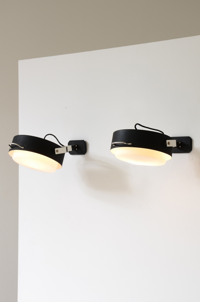Two of four GCME Illuminazione wall lamps circa 1960, featuring circular opaline glass diffusers, dark metal housings, chrome-plated brass details and adjustable wall mounts.