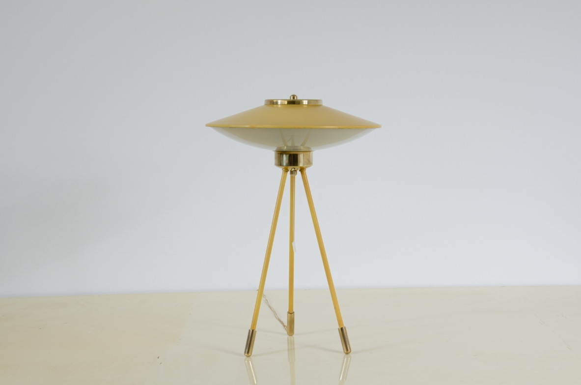 Stilnovo, rare table lamp with metal and brass top and curved glass shade, three metal legs with brass tips.1950