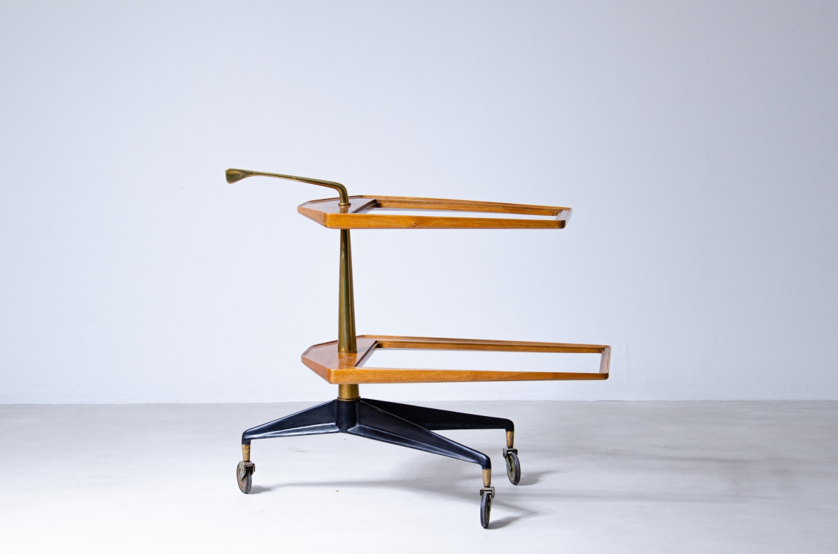 Service table on wheels with two wooden and glass tops. Side upright in shaped brass.  Italian manufacture from the 1950s.