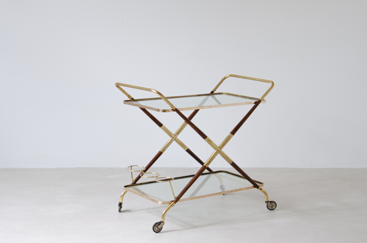 Serving trolley in wood and brass with double glass top and bottle compartments.  Italian manufacture, 1950s.
