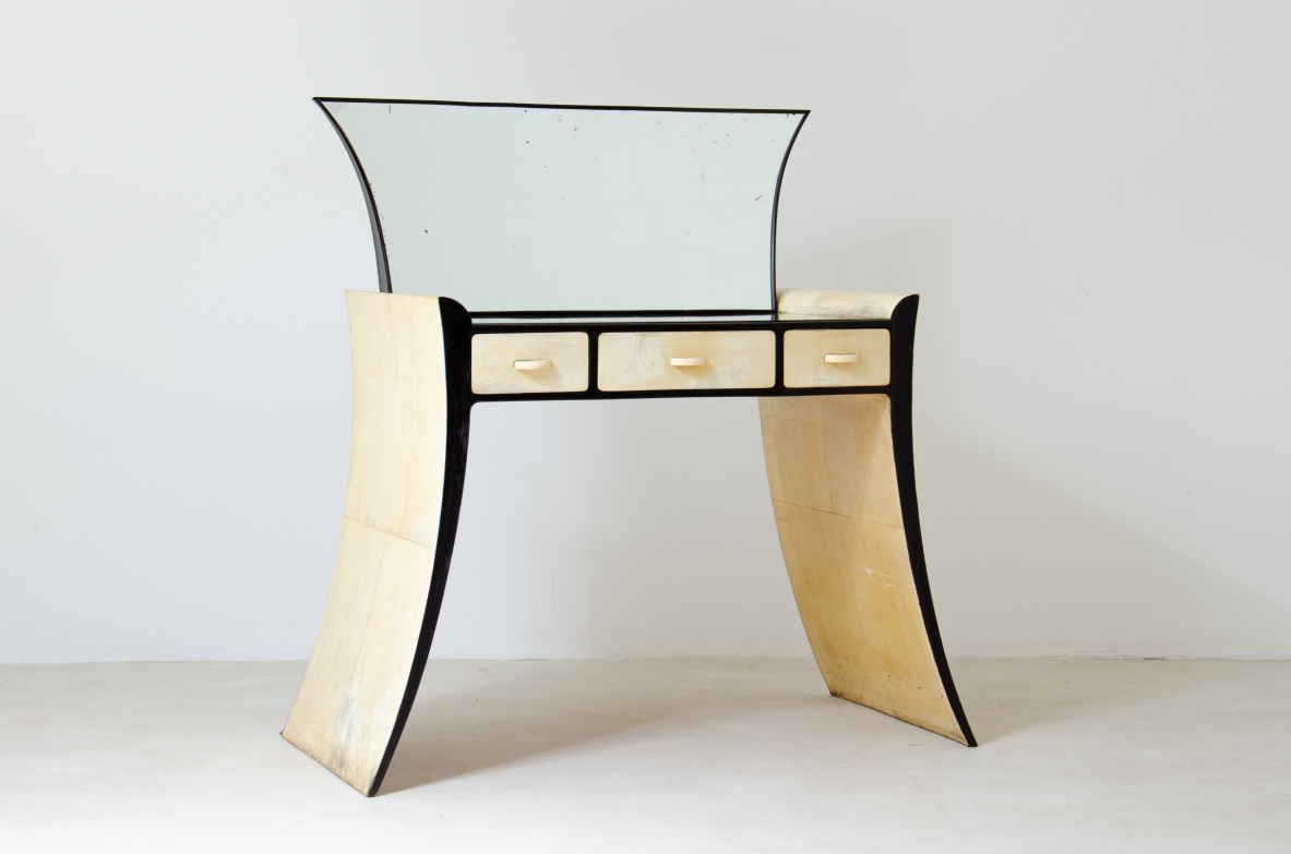 Rare Guglielmo Ulrich console with mirror, manufactured by Arca circa 1940, featuring curved parchment-covered side supports, lacquered wood frame, three drawers with bone knobs and large shaped mirror.