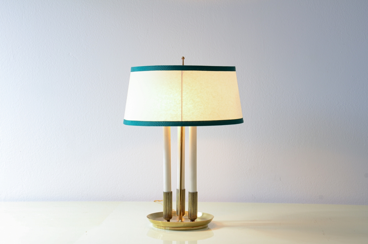 Table lamp with turned base and central stem in brass, three lights in lacquered metal.1940's Italian manufacture.