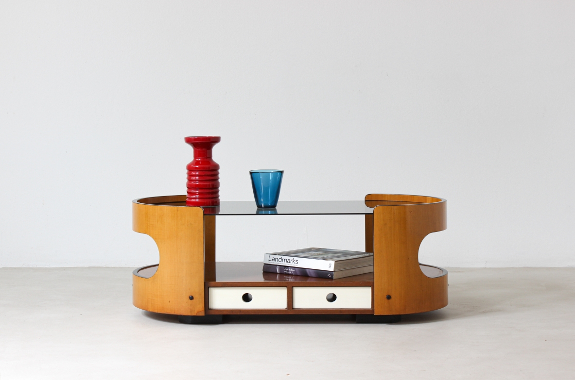 Low table in curved multilayer with two windows on the sides, 4 lacquered wooden drawers and burnished glass top.