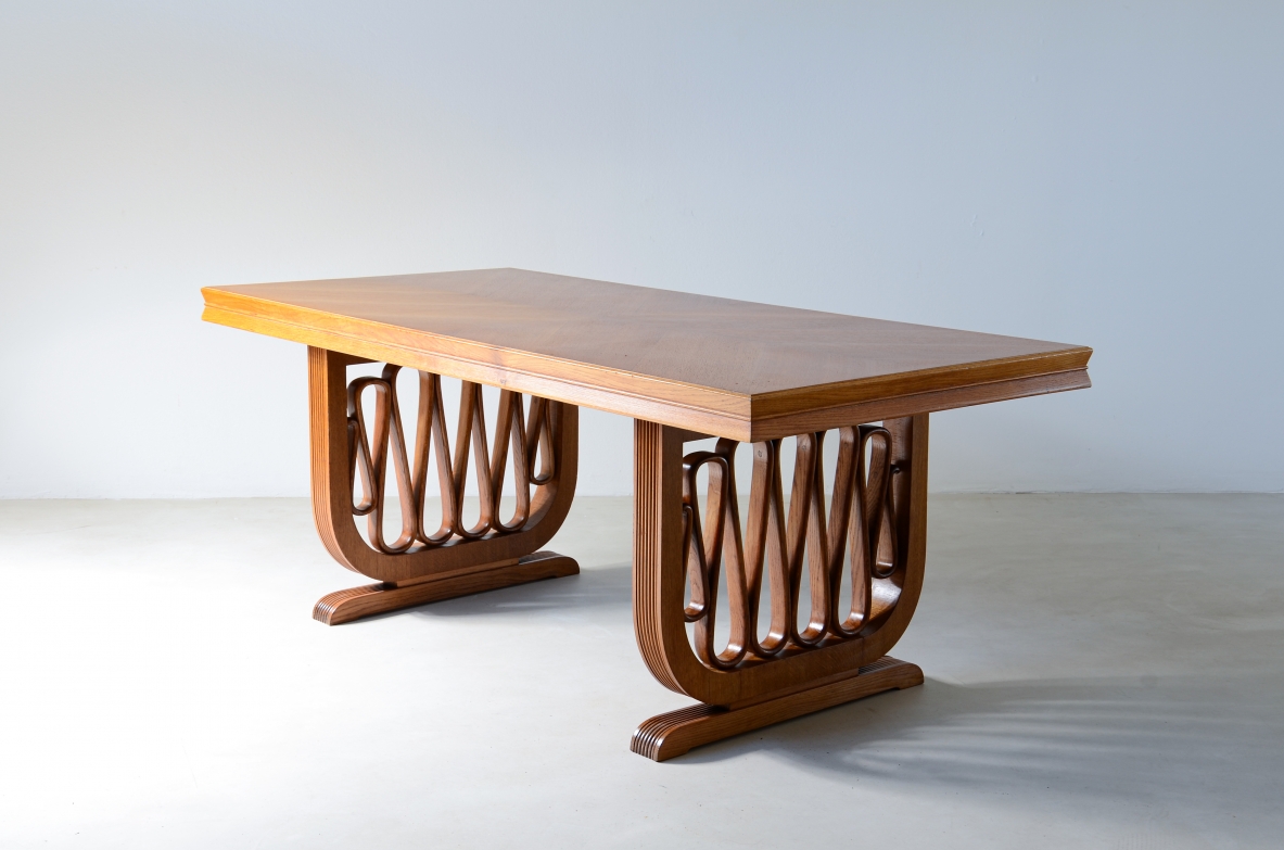 Extraordinary oak table with grissinate uprights and ribbon motif in the style of the period, top with shaped thickness.  Italian manifacture, 1940's