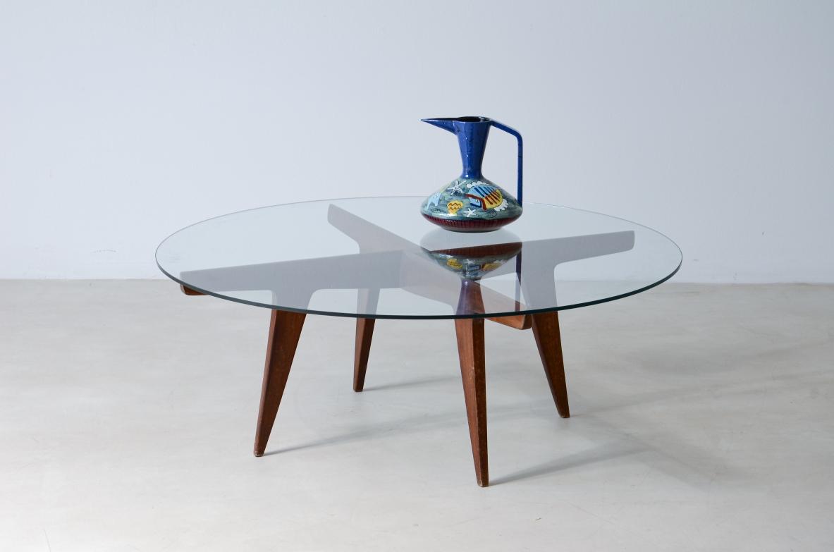 Gio Ponti (1991-1979)  Rare four crossed wooden spokes coffee table with glass top.  1950s manufacturing.  Authentication certificate from the Ponti archive.