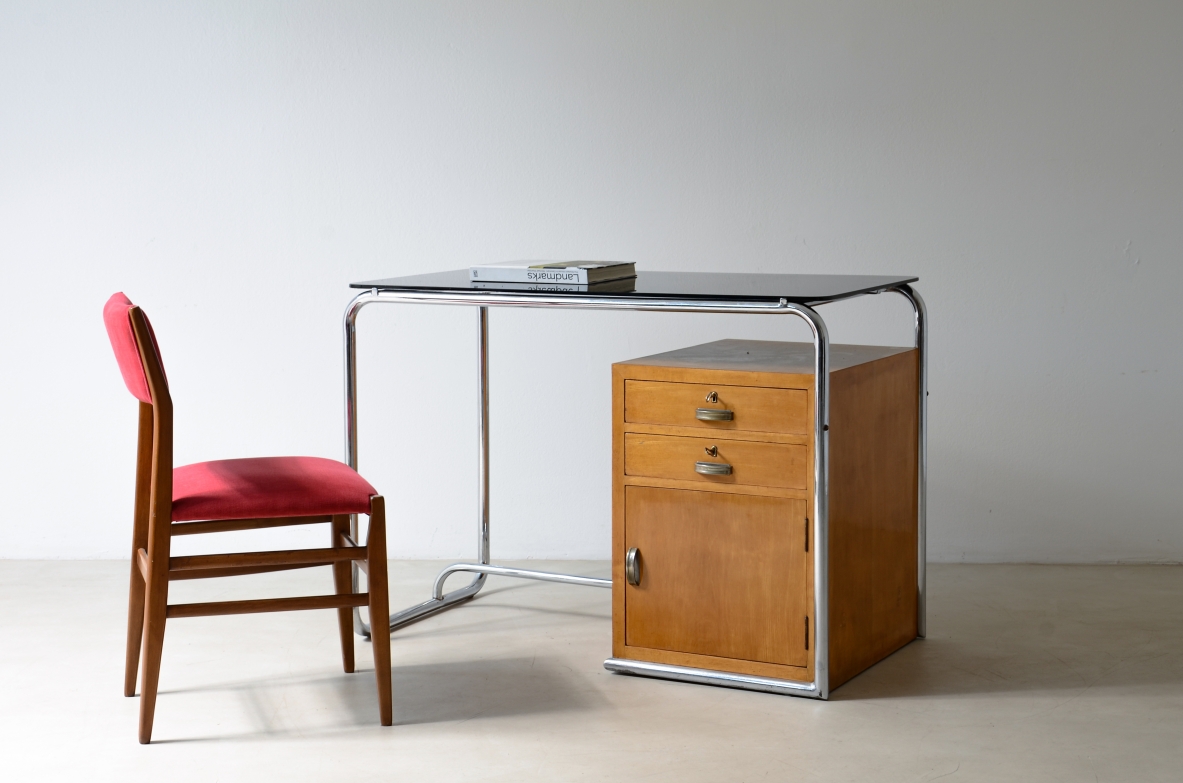 Italian modernist writing desk by Colli Torino, circa 1930, with tubular chrome frame, thick bevelled glass top and wooden side cabinet with two drawers and door.