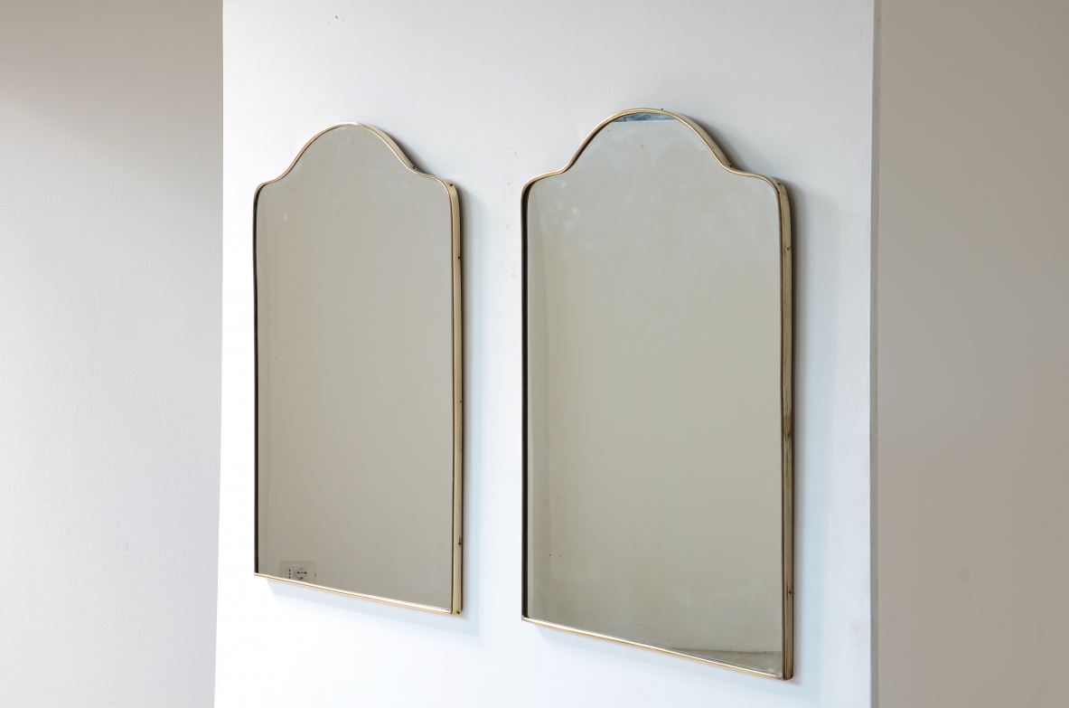 Pair of mirrors with shaped brass frame.  Italian manufacture, 1950s.