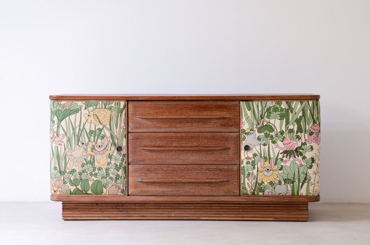 Oak cabinet attributed to Guglielmo Pecorini with four drawers and two patterned fabric-covered doors, late 1930s.
