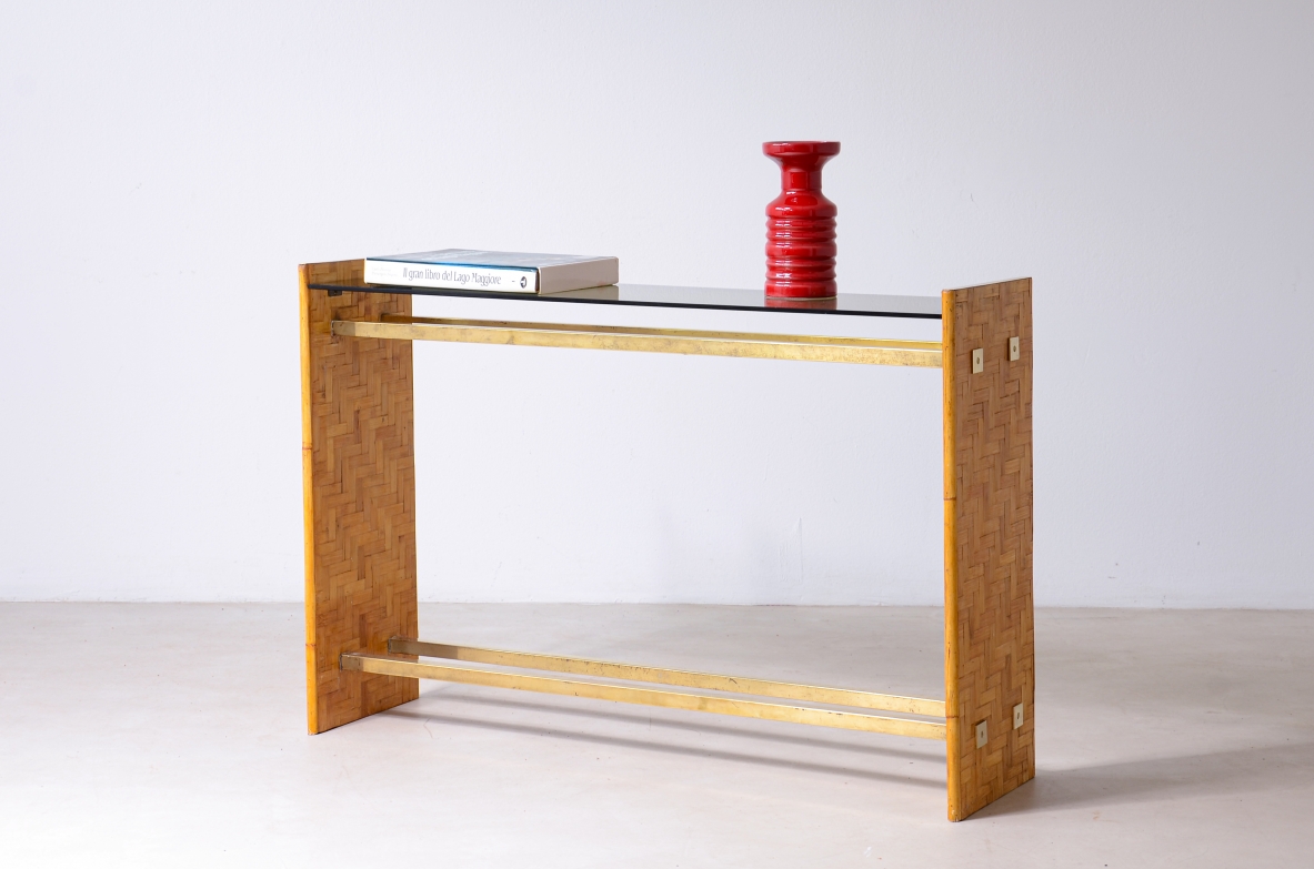 Italian console table two raffia-covered wooden side supports, horizontal brass stretchers and rectangular smoked glass top.