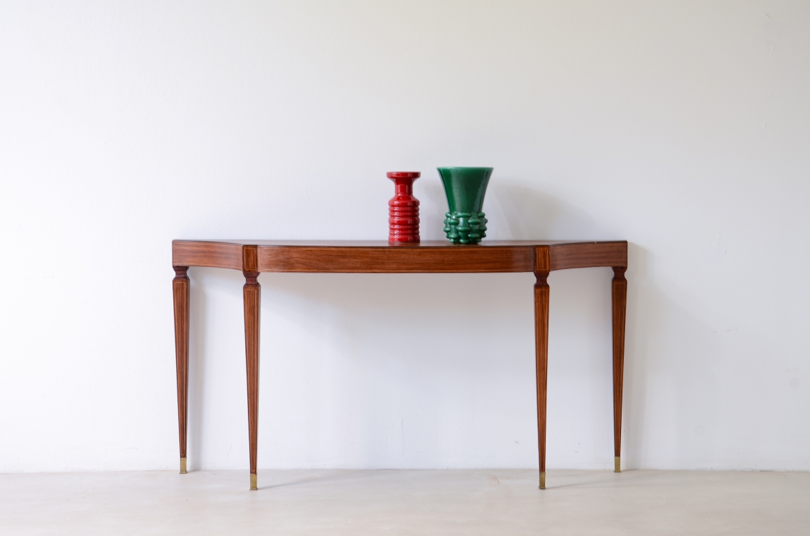 Italian console with subtly shaped top, maple inlays along the top and apron, four tapered square-section legs and brass feet.