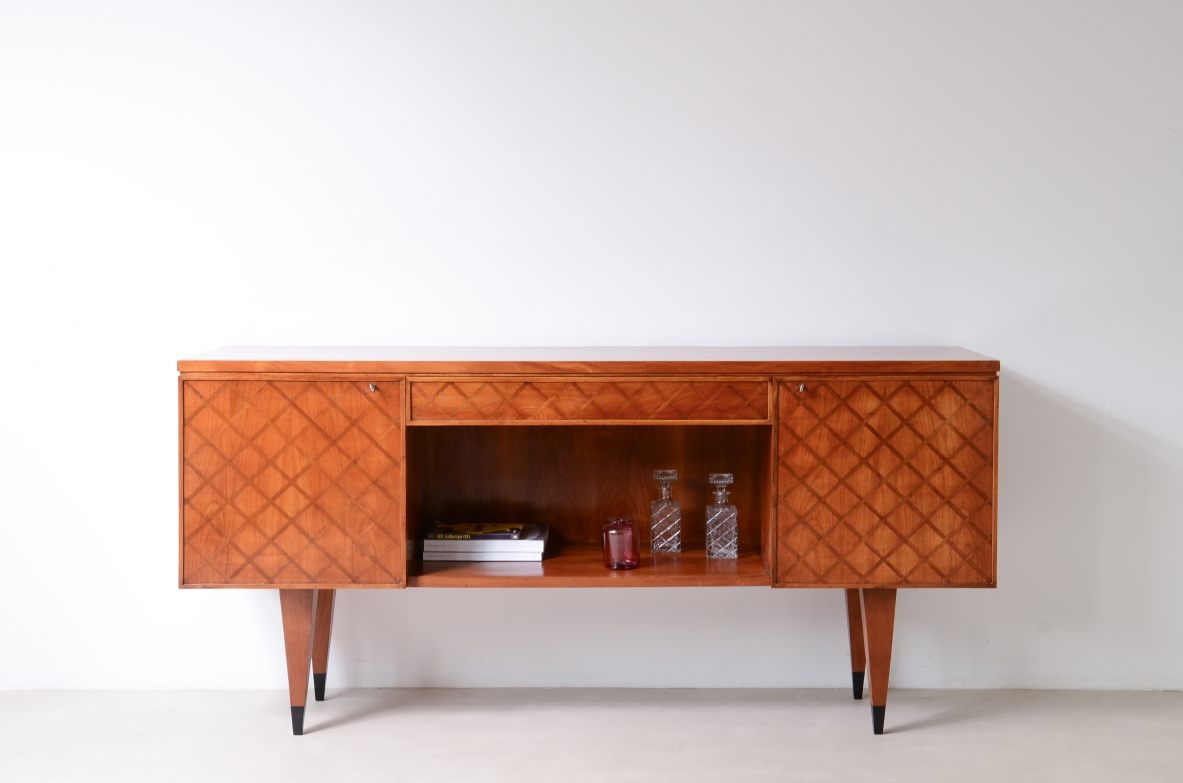 Elegant 1950s highboard by Gio Ponti featuring a checkerboard inlaid front, side doors and ebonized details. Certified by the Gio Ponti Archive