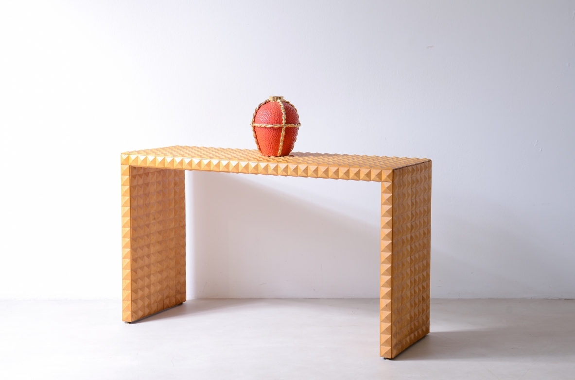 Italian console table circa 1970, with rectangular waterfall-style structure entirely covered in geometric diamond-cut wooden tiles.