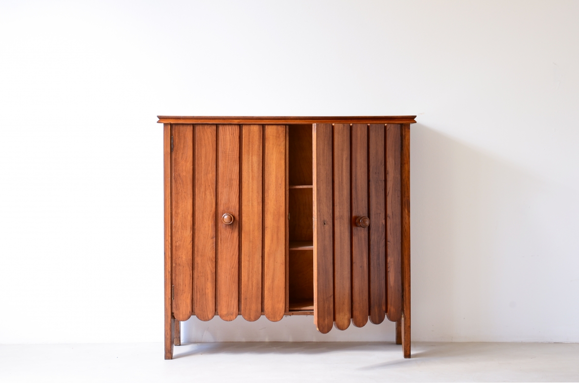 Italian 1940s light oak cabinet with slatted doors featuring a decorative wave motif.