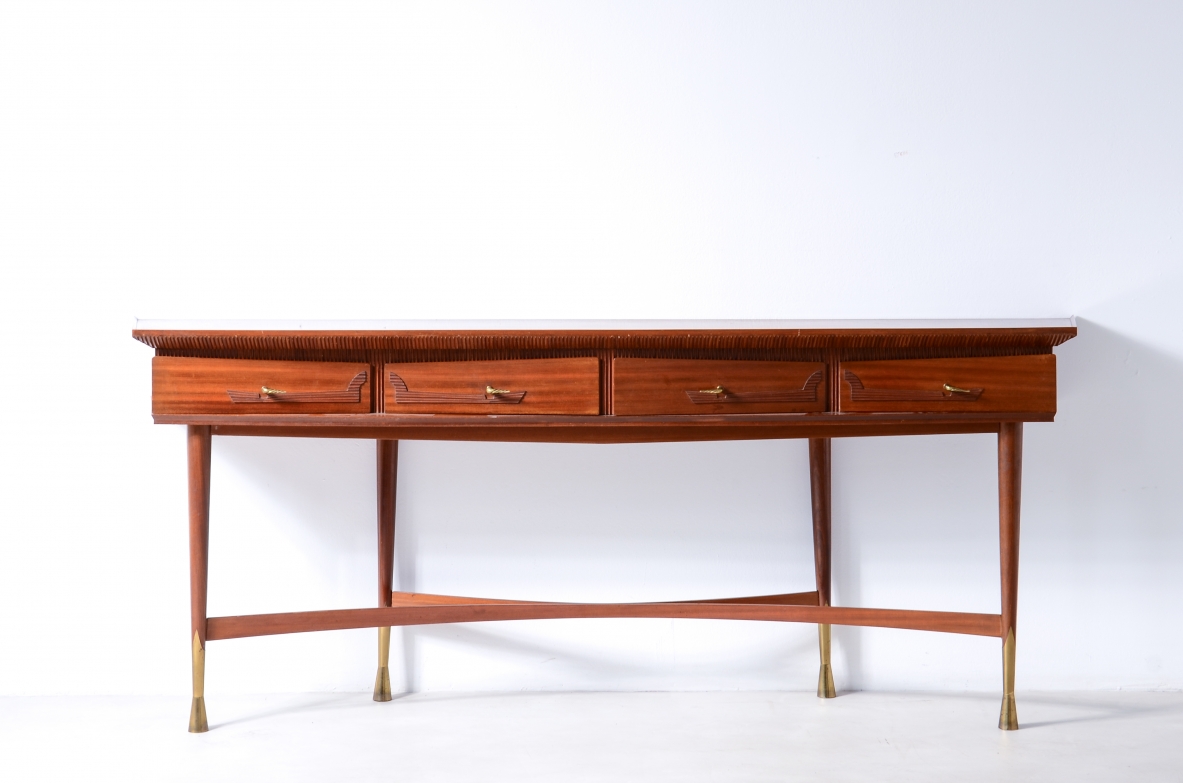 Large Italian console table circa 1950, with four shaped front drawers, curved sides, turned legs with long brass feet and double-arched lower stretcher, front view.