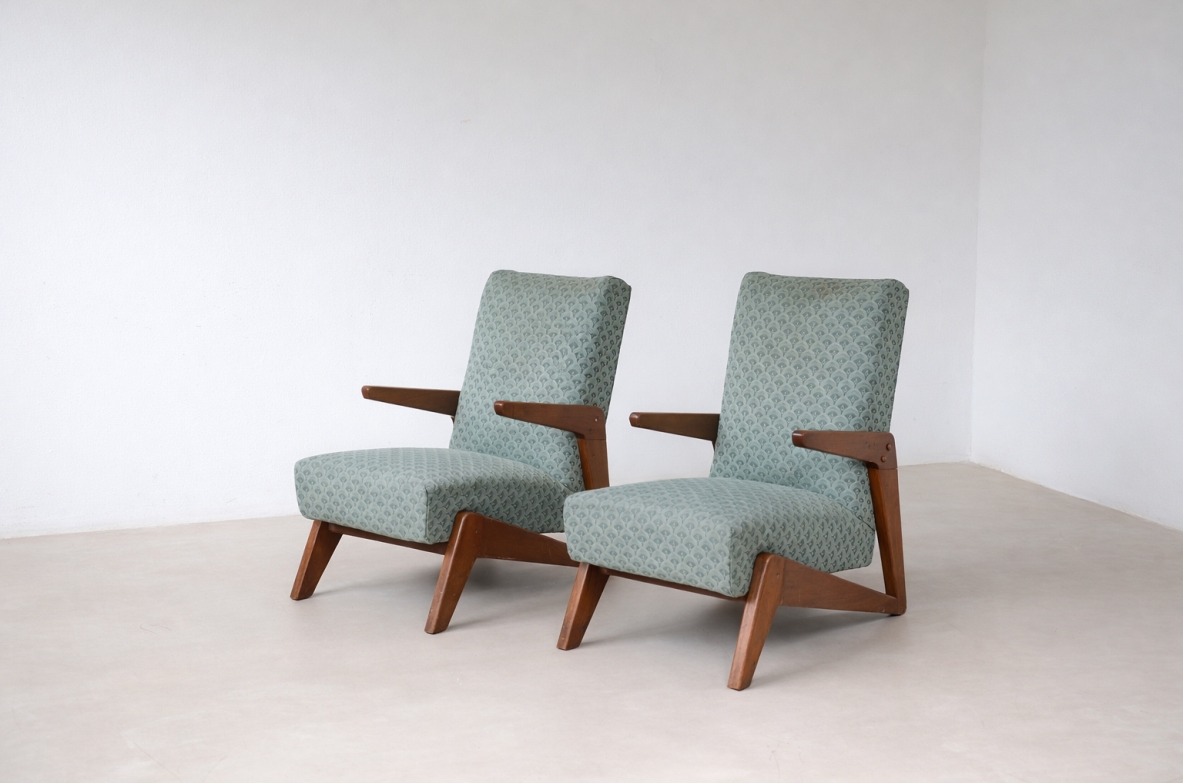 Pair of modernist armchairs by José Zanin Caldas, featuring sculptural oak frames, angled legs, geometric wooden armrests and aqua-green upholstered seats and backrests.