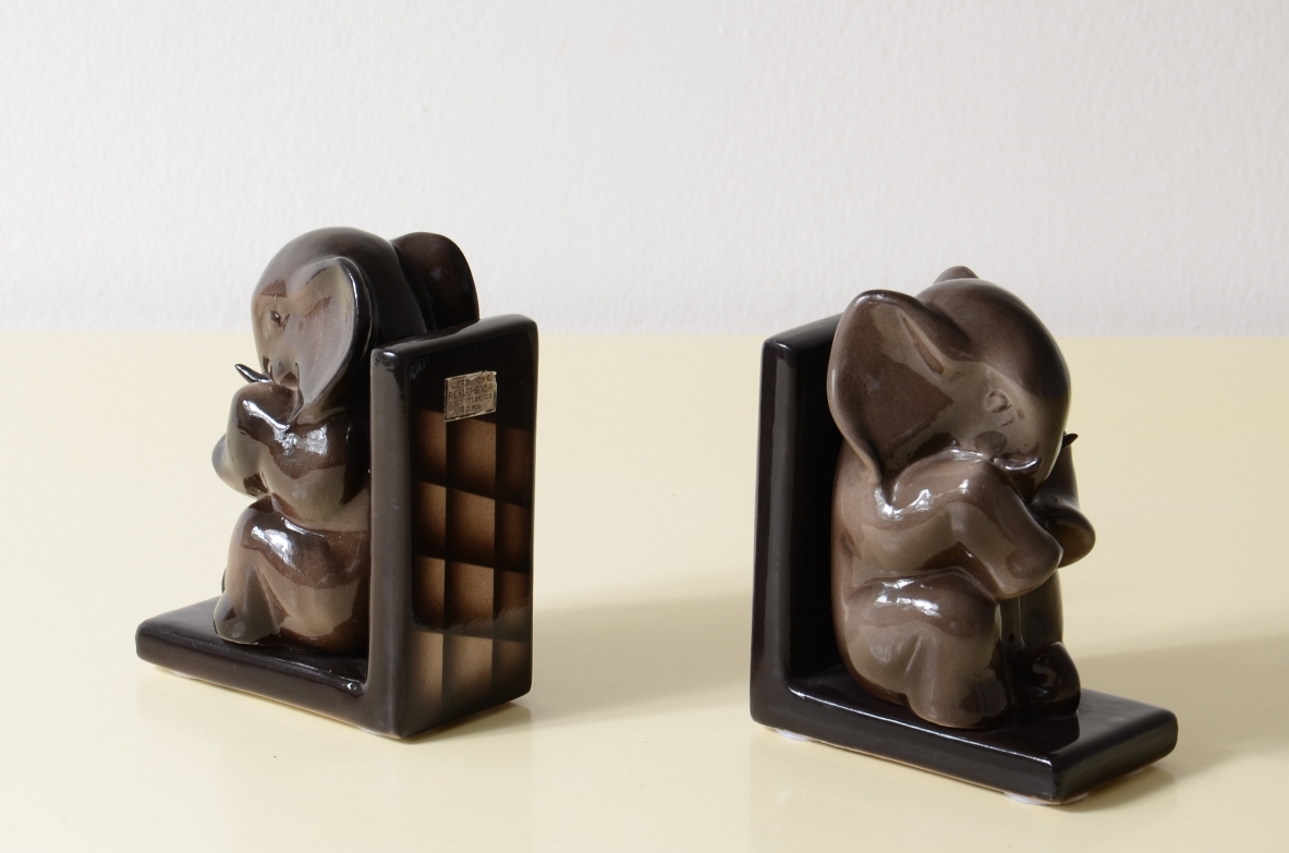 Rara coppia di fermalibri Richard Ginori del 1930 circa, con sculture decorative in ceramica smaltata marrone scuro su basi ad angolo retto, fotografate di tre quarti.
